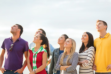 Image showing group of friends looking up on the beach