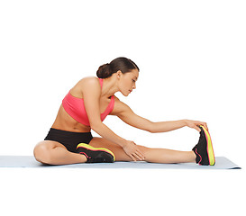 Image showing sporty woman doing exercise on the floor