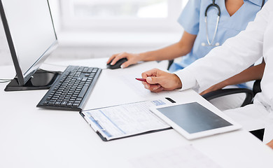 Image showing group of doctors looking at tablet pc