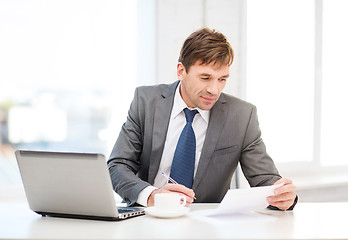 Image showing businessman with laptop computer and documents