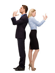 Image showing businesswoman and businessman with imaginary guns