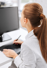 Image showing businesswoman with drawing tablet in office