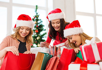 Image showing women in santa helper hats with shopping bags