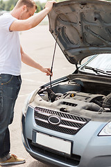 Image showing man opening car bonnet