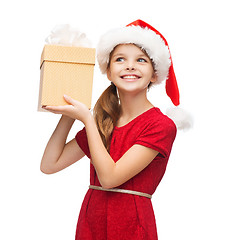 Image showing smiling girl in santa helper hat with gift box