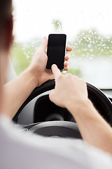 Image showing man using phone while driving the car