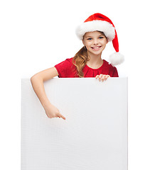 Image showing woman in santa helper hat with blank white board