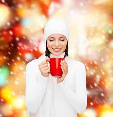 Image showing woman in hat with red tea or coffee mug