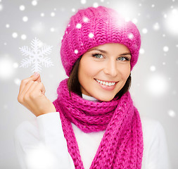 Image showing woman in hat and muffler with big snowflake