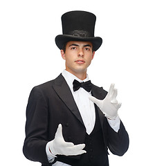 Image showing magician in top hat showing trick