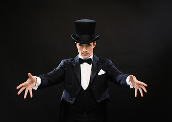 Image showing magician in top hat showing trick