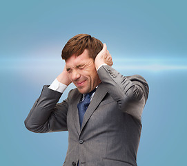 Image showing stressed buisnessman or teacher closing ears