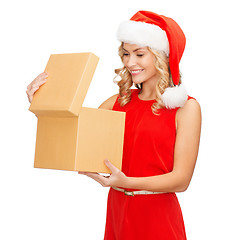 Image showing smiling woman in santa helper hat with gift box