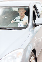 Image showing man placing parking clock on car dashboard