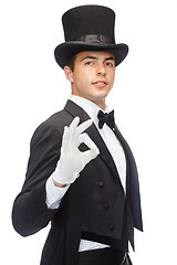 Image showing magician in top hat showing trick