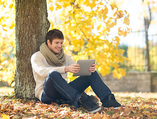 Image showing man with tablet pc in autumn park