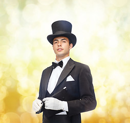 Image showing magician in top hat with magic wand showing trick