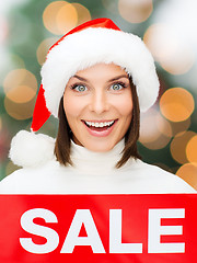 Image showing woman in santa helper hat with red sale sign