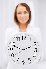 Image showing attractive businesswoman with white clock