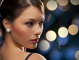 Image showing woman in evening dress wearing diamond earrings