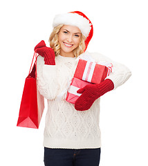 Image showing woman in santa helper hat with shopping bags