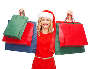 Image showing woman in red dress with shopping bags