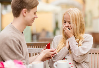 Image showing romantic man proposing to beautiful woman