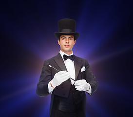 Image showing magician in top hat with magic wand showing trick