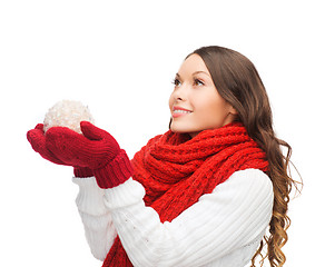 Image showing woman in scarf and mittens with christmas ball