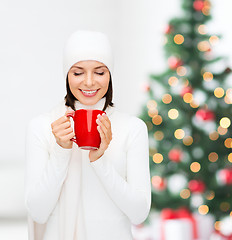 Image showing woman in hat with red tea or coffee mug