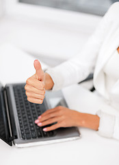 Image showing businesswoman with laptop showing thumbs up