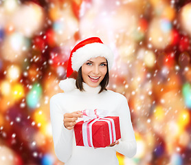 Image showing smiling woman in santa helper hat with gift box