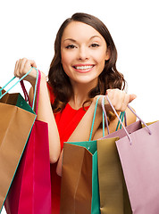 Image showing woman in red dress with shopping bags
