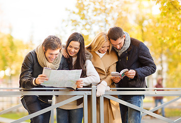 Image showing couples with tourist map in autumn park