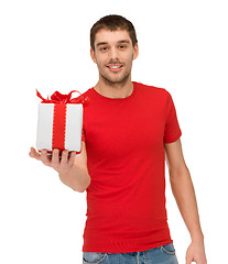 Image showing smiling man in red shirt with gift box