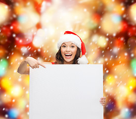 Image showing woman in santa helper hat with blank white board