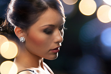 Image showing woman in evening dress wearing diamond earrings