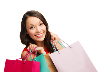 Image showing woman in red dress with shopping bags