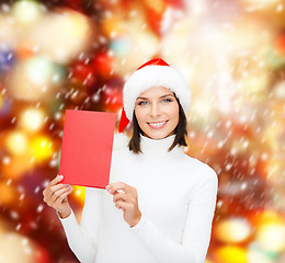 Image showing woman in santa helper hat with blank red card