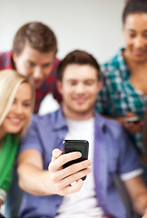 Image showing students looking at smartphone at school