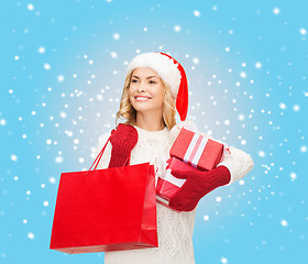 Image showing woman in santa helper hat with shopping bags