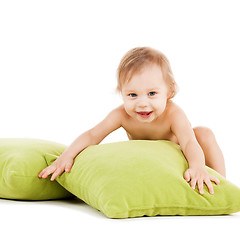 Image showing cute little boy playing with green pillows