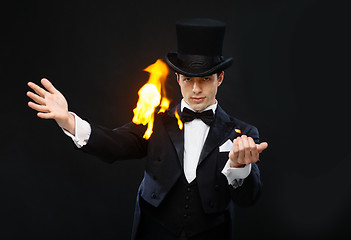 Image showing magician in top hat showing trick with fire