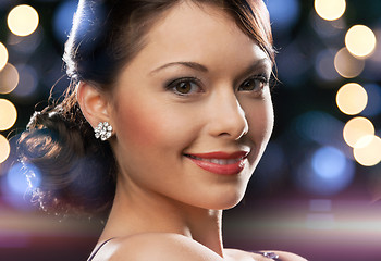 Image showing woman in evening dress wearing diamond earrings