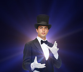 Image showing magician in top hat showing trick