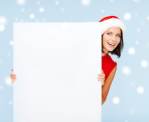 Image showing woman in santa helper hat with blank white board