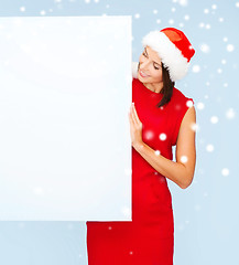 Image showing woman in santa helper hat with blank white board