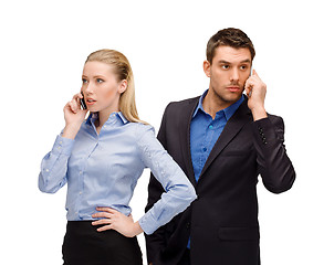 Image showing woman and man with cell phones calling