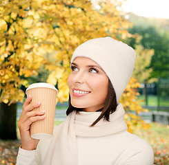 Image showing woman in hat with takeaway tea or coffee cup