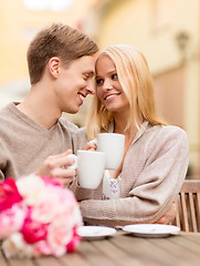 Image showing romantic happy couple kissing in the cafe